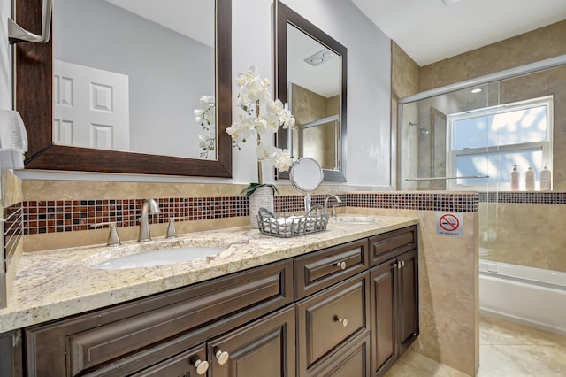 bathroom with vanity and shower / bath combination with glass door