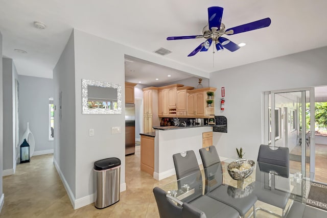 dining space with ceiling fan and light tile patterned floors