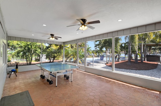 recreation room with ceiling fan and plenty of natural light