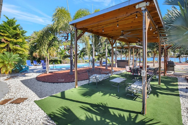 view of home's community with a pool with hot tub