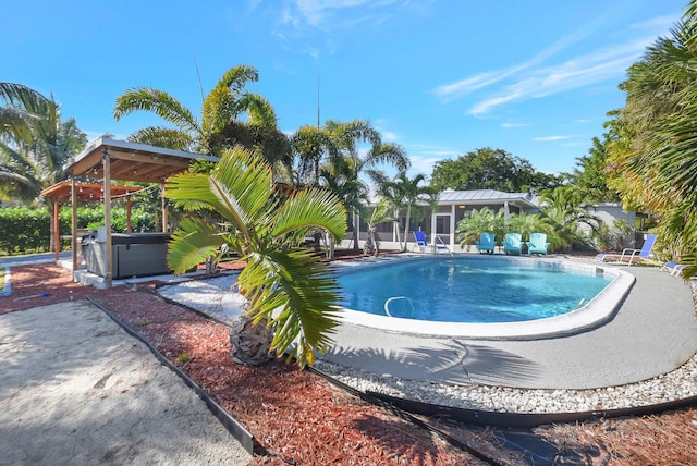 view of swimming pool with a patio area and a jacuzzi