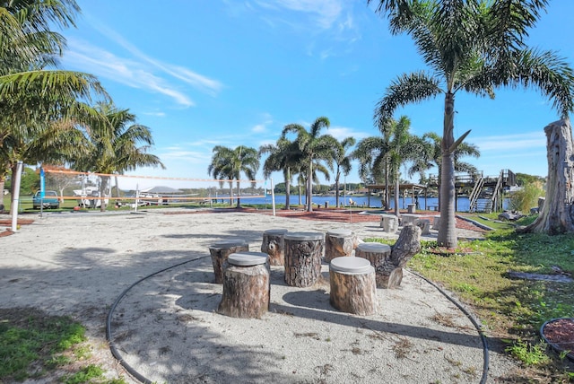 exterior space featuring volleyball court and a water view