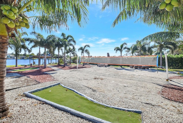 view of community featuring volleyball court and a water view