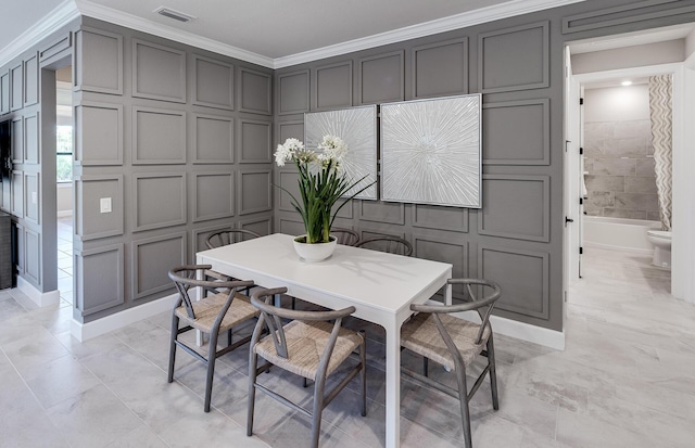 dining space with ornamental molding