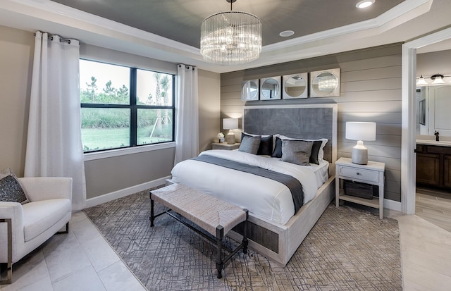 bedroom featuring an inviting chandelier, crown molding, a raised ceiling, and sink