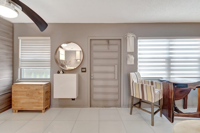 entryway featuring tile patterned flooring and a textured ceiling