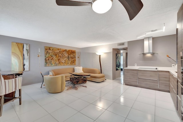 tiled living room featuring a textured ceiling