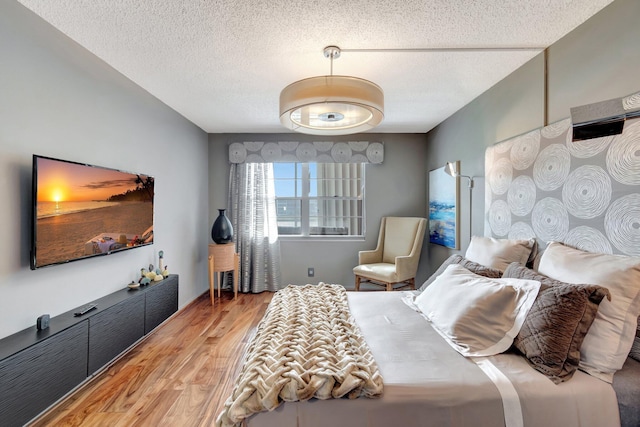 bedroom featuring a textured ceiling and hardwood / wood-style floors