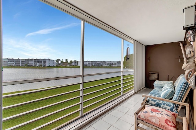 sunroom / solarium featuring a water view