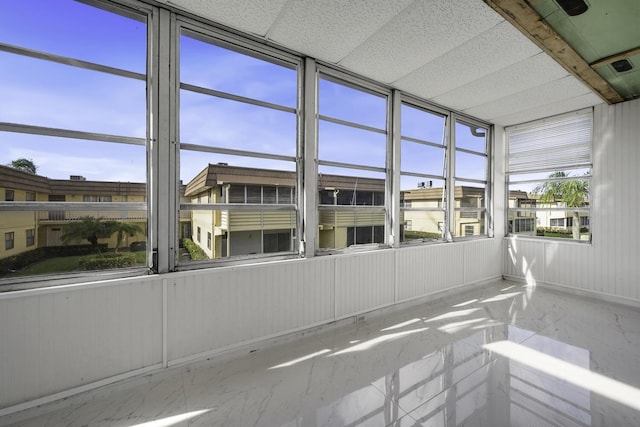 unfurnished sunroom with a paneled ceiling