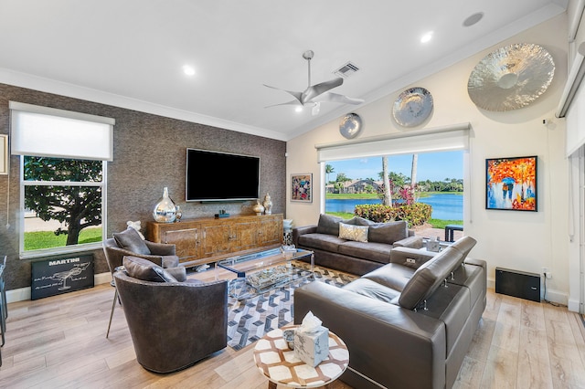 living room with ornamental molding, vaulted ceiling, ceiling fan, and light hardwood / wood-style flooring