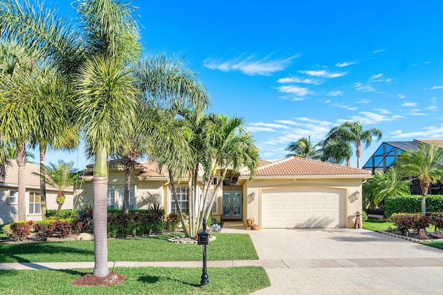 mediterranean / spanish home with french doors and a front yard