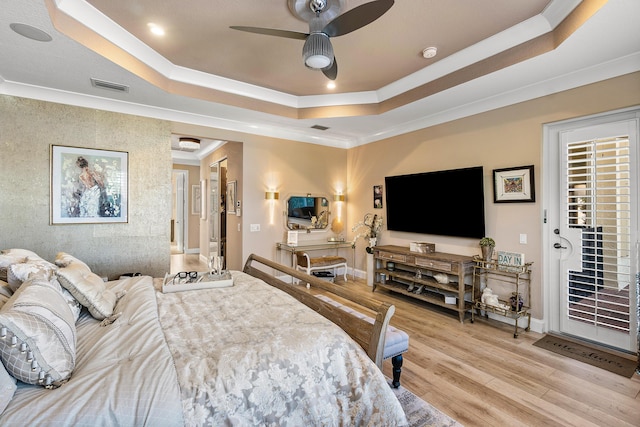 bedroom featuring access to exterior, ceiling fan, crown molding, and a tray ceiling