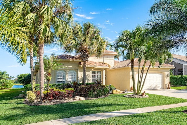 mediterranean / spanish-style home with a garage and a front yard