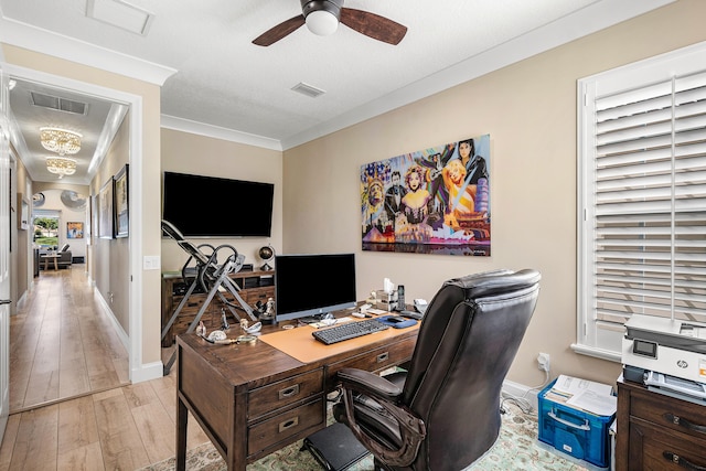 home office with ceiling fan, light hardwood / wood-style flooring, a textured ceiling, and crown molding