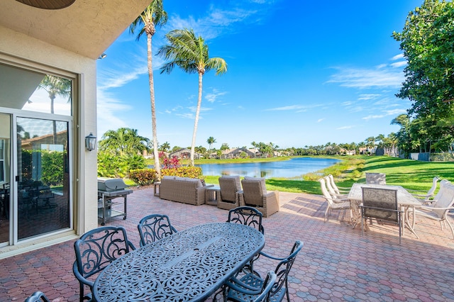 view of patio / terrace with a water view, grilling area, and outdoor lounge area