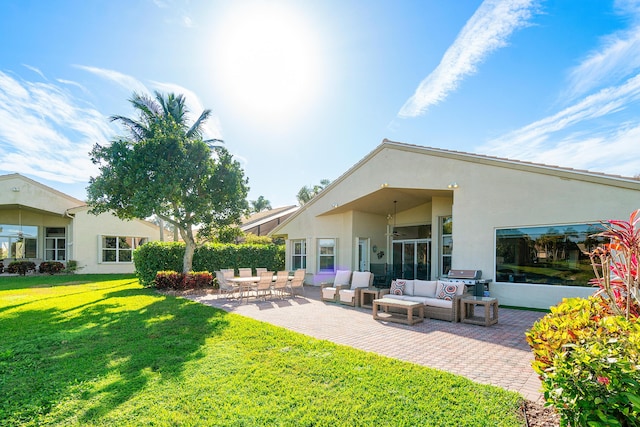 rear view of house with a patio, a yard, and an outdoor hangout area