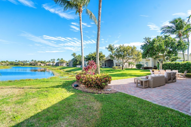 view of yard with a water view and a patio