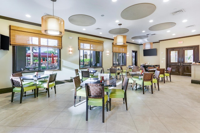 dining area with ornamental molding, plenty of natural light, and light tile patterned flooring