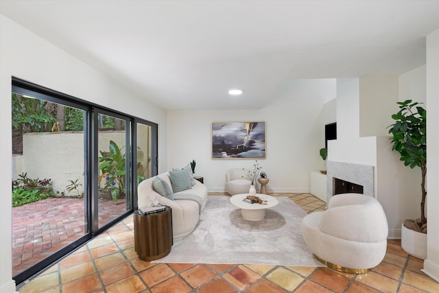 living room with a fireplace and light tile patterned floors