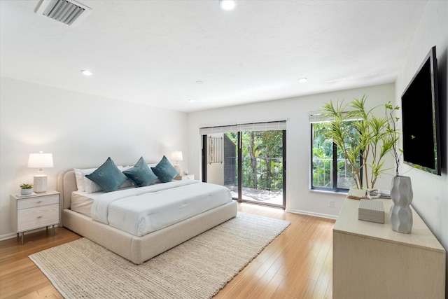 bedroom featuring access to outside and light wood-type flooring