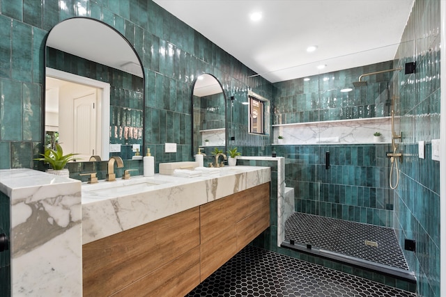 bathroom featuring tile walls, tile patterned flooring, an enclosed shower, and vanity