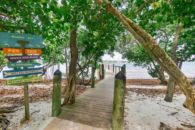 view of property's community with a boat dock and a water view