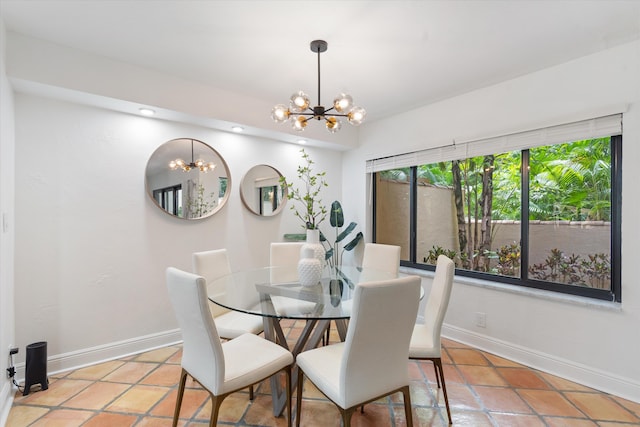 dining area featuring an inviting chandelier and light tile patterned flooring