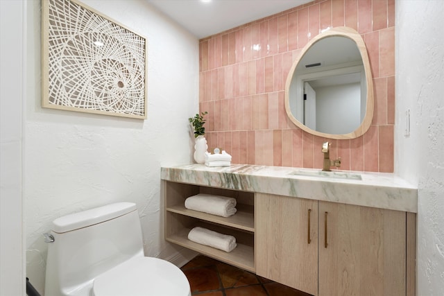 bathroom with toilet and vanity