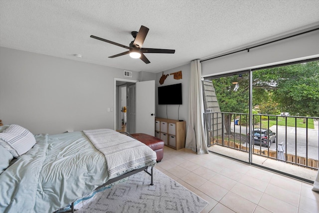 bedroom with access to outside, a textured ceiling, ceiling fan, and light tile patterned floors