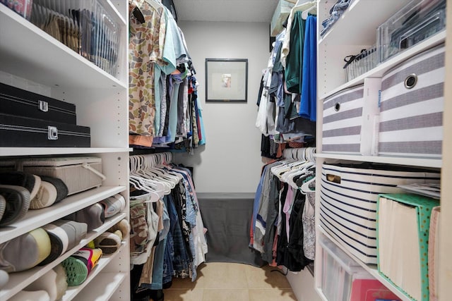 spacious closet with tile patterned floors