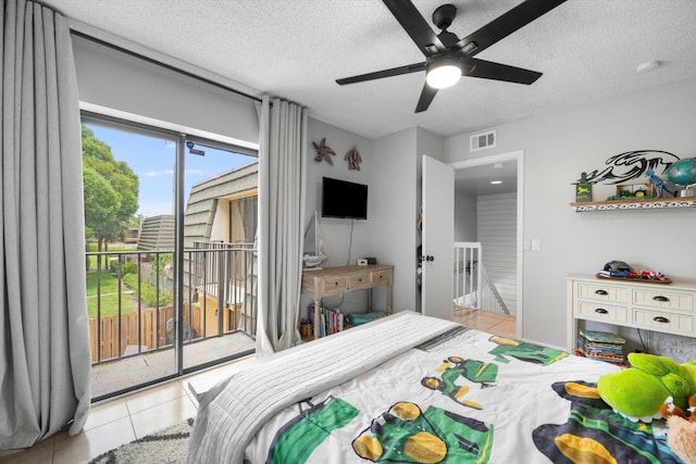 bedroom featuring access to outside, a textured ceiling, ceiling fan, and light tile patterned floors