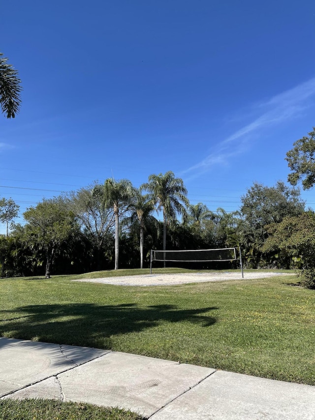 view of home's community featuring a lawn and volleyball court