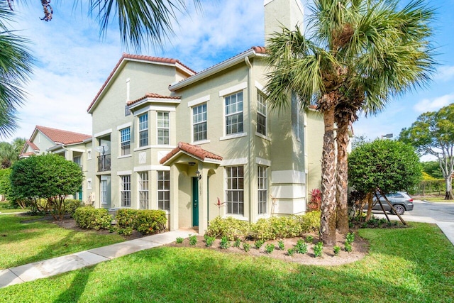 mediterranean / spanish-style home featuring a front lawn