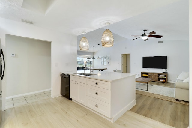 kitchen with black dishwasher, a sink, visible vents, and white cabinets