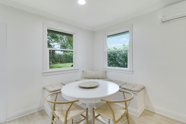 dining area with baseboards, an AC wall unit, light wood-style flooring, and crown molding