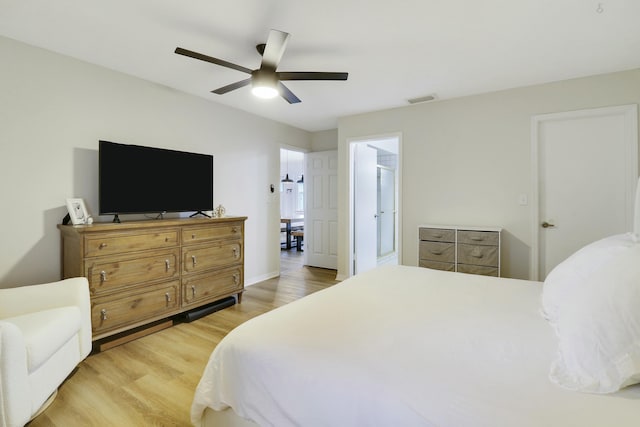 bedroom featuring light wood-type flooring, baseboards, visible vents, and a ceiling fan