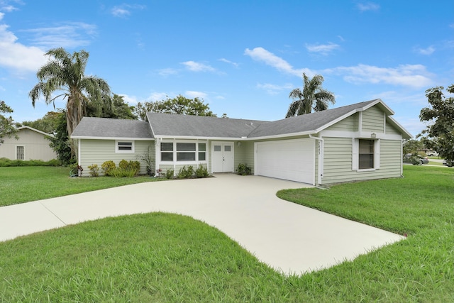 ranch-style house with a garage and a front lawn