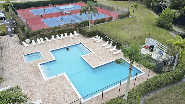 view of pool with a tennis court and fence