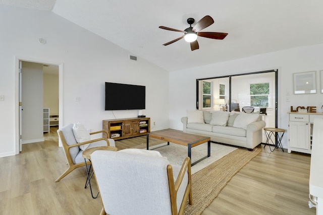 living room with visible vents, vaulted ceiling, light wood finished floors, and ceiling fan