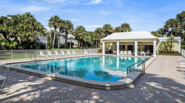 view of pool featuring a patio and ceiling fan