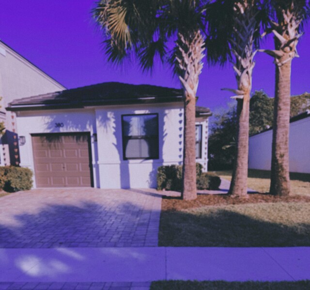 view of front facade with a front yard and a garage