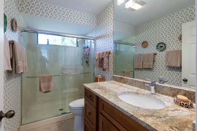 bathroom featuring walk in shower, vanity, and toilet