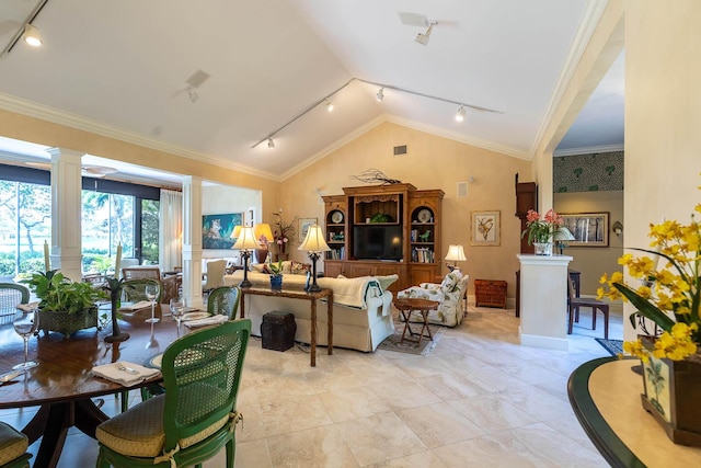 living room featuring crown molding, lofted ceiling, rail lighting, and ornate columns