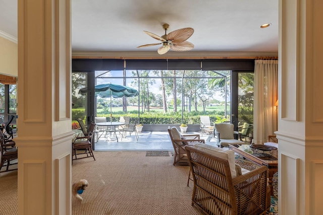 sunroom with decorative columns and ceiling fan