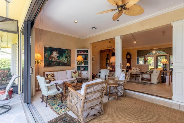 living room with decorative columns, light tile patterned floors, ceiling fan, crown molding, and french doors