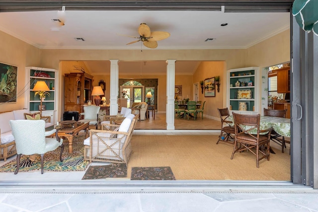 tiled living room with ornamental molding, ceiling fan, and ornate columns