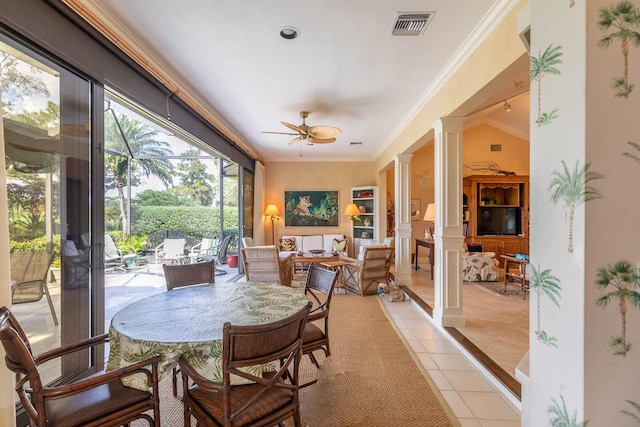 sunroom featuring ceiling fan and decorative columns