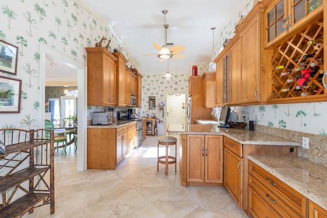 kitchen with pendant lighting, a kitchen bar, light stone counters, stainless steel appliances, and crown molding