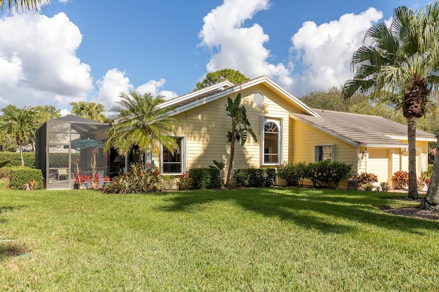 view of front of house with a lanai and a front yard